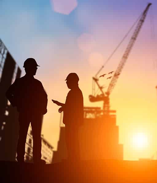 Haztek Inc. - Two safety management workers in silhouette at sunset.