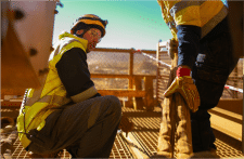 Managers implementing expert safety solutions while working at construction site.