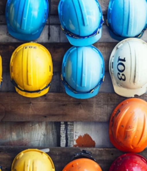Haztek Inc.: Hard hats of various colors hanging on a wall.
