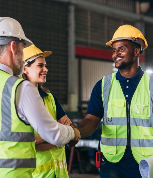 Haztek Inc. - Two construction safety consultants shaking hands while a third looks on with a smile.