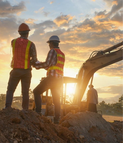 Haztek Inc. - Two professionals from a top safety consulting company working on site at sunset.