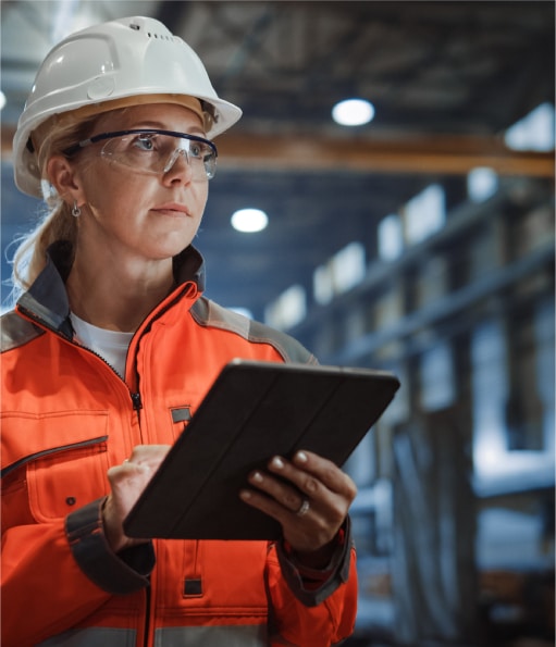 Close-up photo of Haztek Inc. construction safety consultant recording data on tablet.