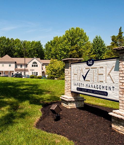 Haztek safety company office location lined with grass and trees.